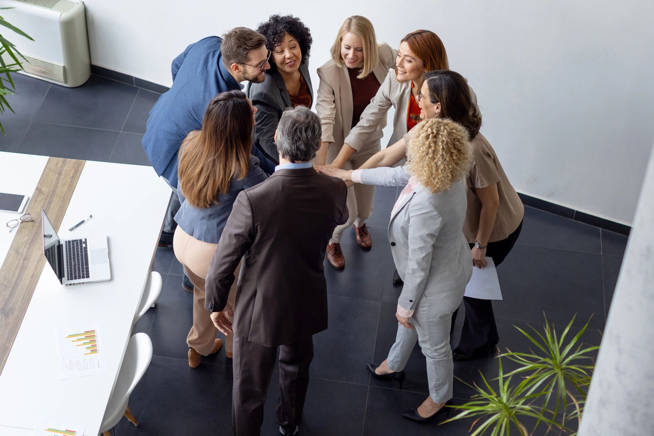 Team members celebrating success in bright workspace