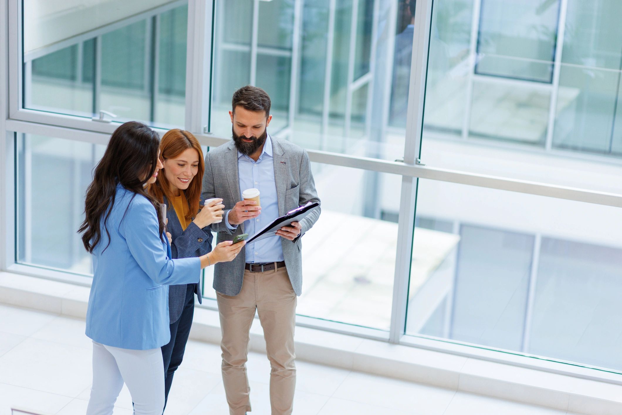 Business professionals reviewing work together in a modern office